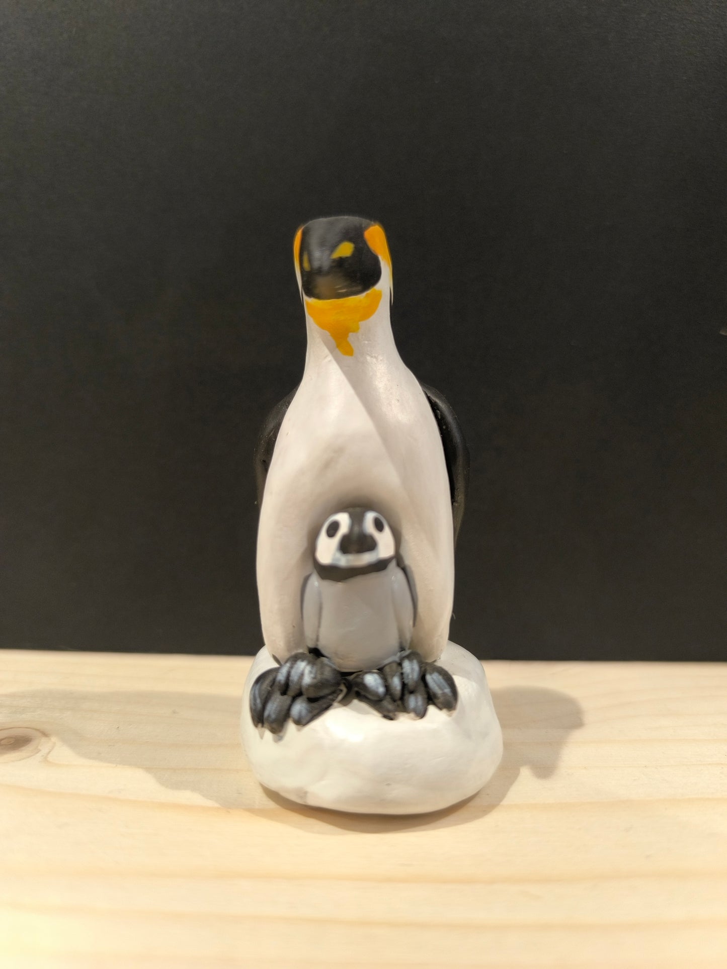 Emperor Penguin Protecting Its Chick 
