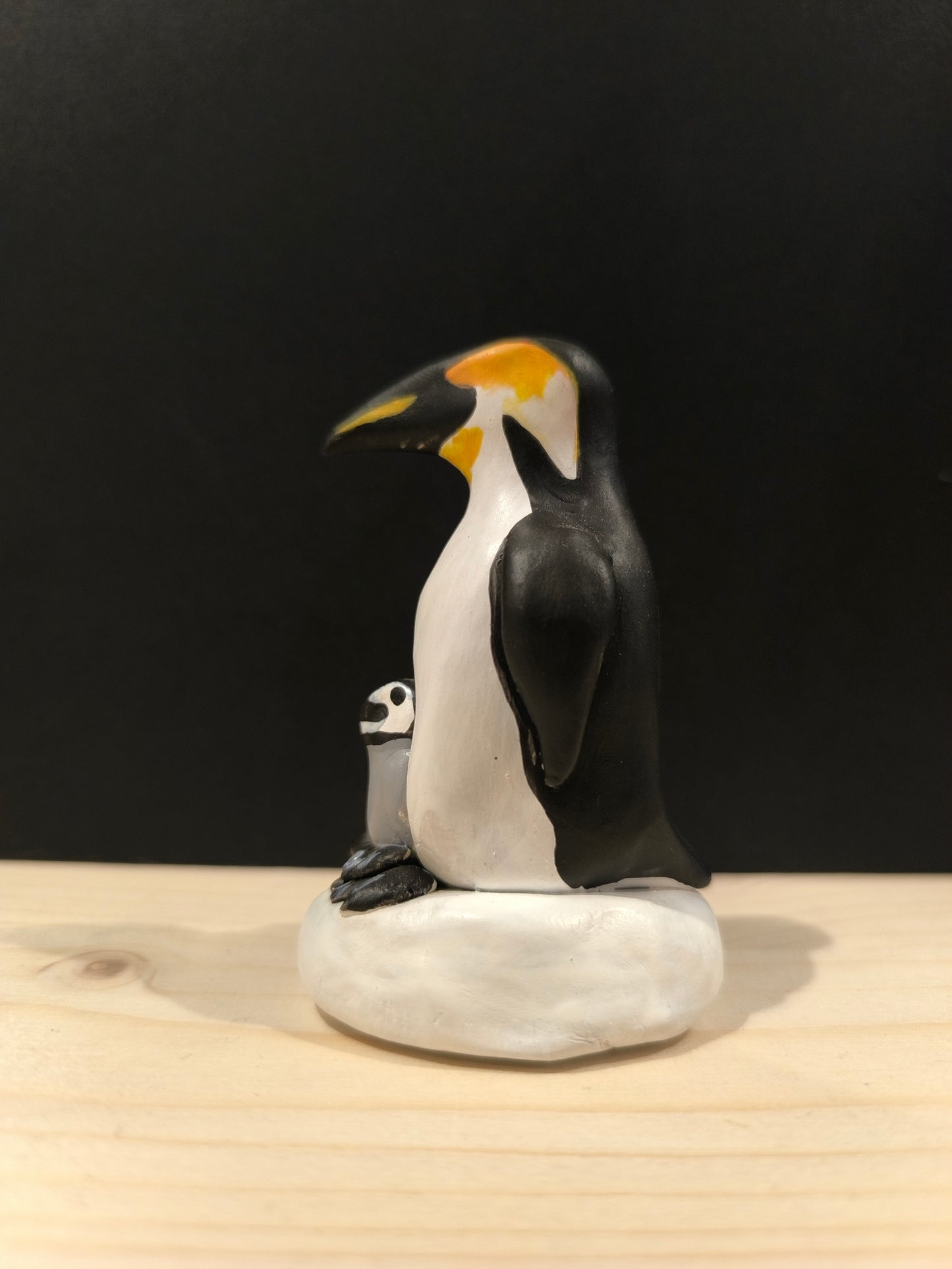 Emperor Penguin Protecting Its Chick 