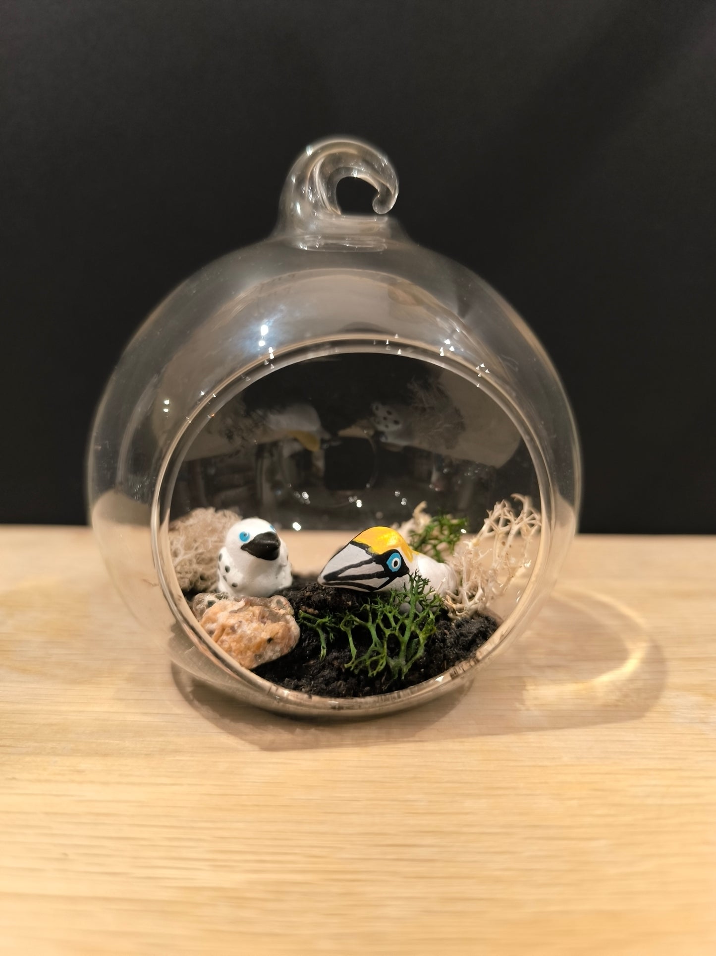 Figurine sculptée miniature Fou de bassan avec son petit dans petite bulle de verre avec décor.